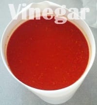 Adding vinegar to chilli pulp