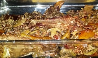 Chicken pieces with mushrooms bacon etc sprinkled on top in oven  coq au vin