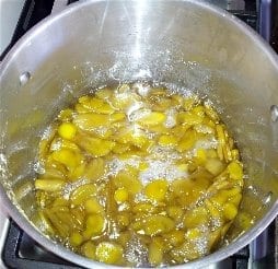 Sliced ginger cooking in pot