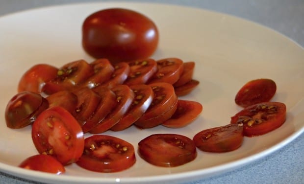 black plum tomato cut on plate