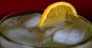 home made orange cordial close up glass with ice