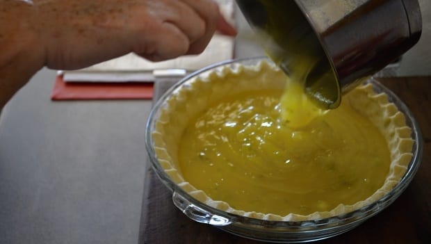 pouring lime filling into gluten free pie base 