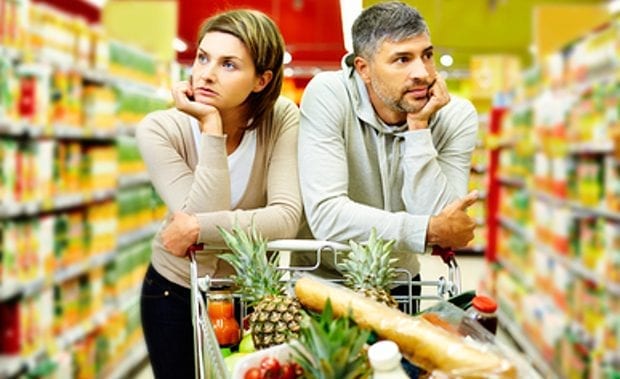 supermarket unhappy couple pushing trolly